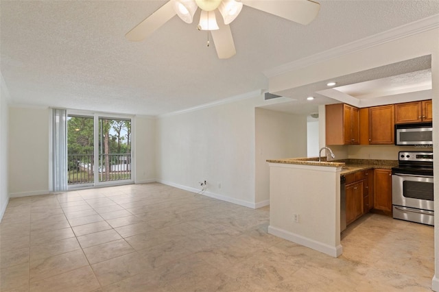 kitchen featuring a textured ceiling, stainless steel appliances, ceiling fan, and ornamental molding