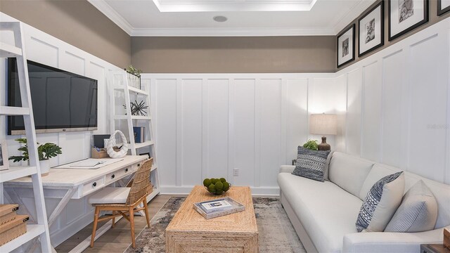 office with light hardwood / wood-style floors and ornamental molding