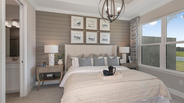 bedroom with carpet, ensuite bathroom, ornamental molding, and an inviting chandelier