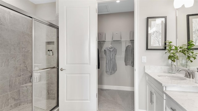 bathroom with vanity and a shower with door