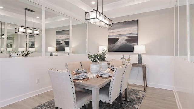 dining space featuring hardwood / wood-style floors and ornamental molding