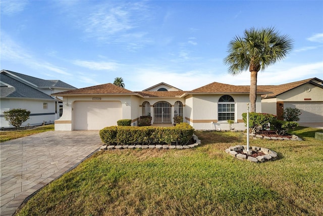 view of front of home featuring a garage and a front yard