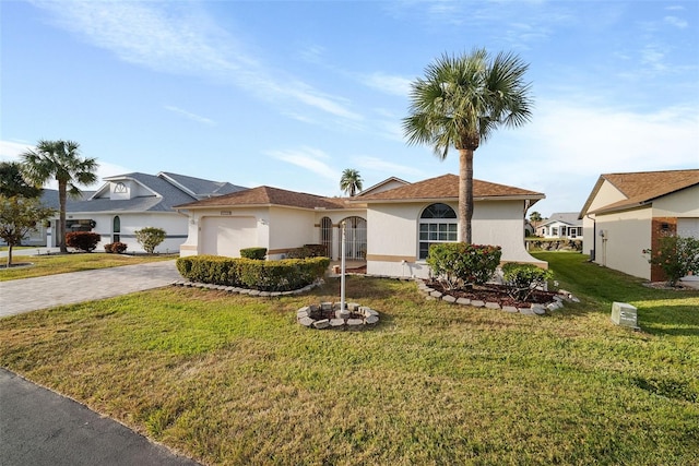 view of front facade featuring a front yard and a garage