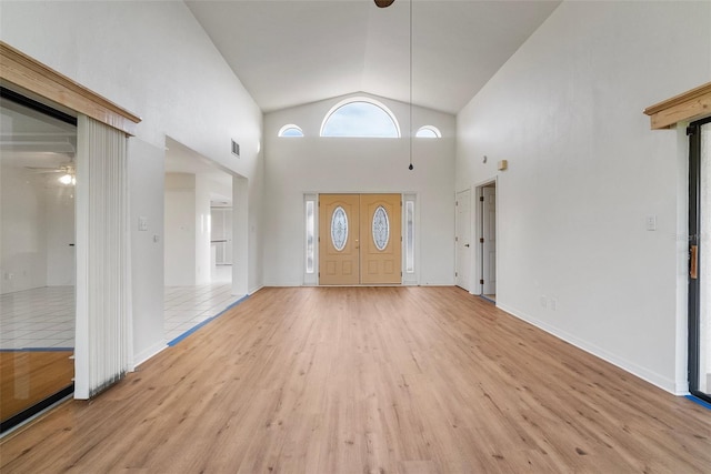 entryway featuring ceiling fan, light hardwood / wood-style floors, and high vaulted ceiling