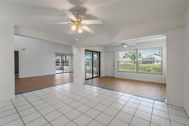 spare room featuring ceiling fan and light hardwood / wood-style floors