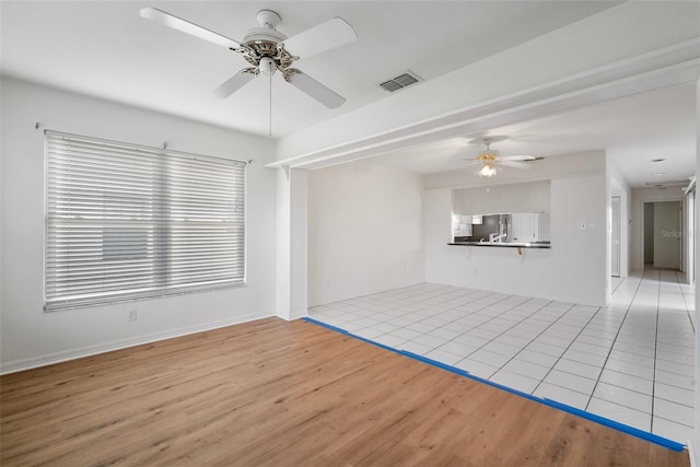 unfurnished living room with ceiling fan and light hardwood / wood-style floors