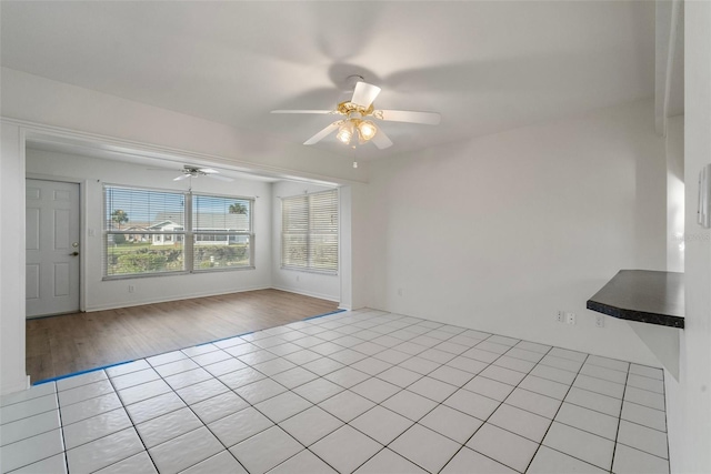 unfurnished room featuring ceiling fan and light wood-type flooring