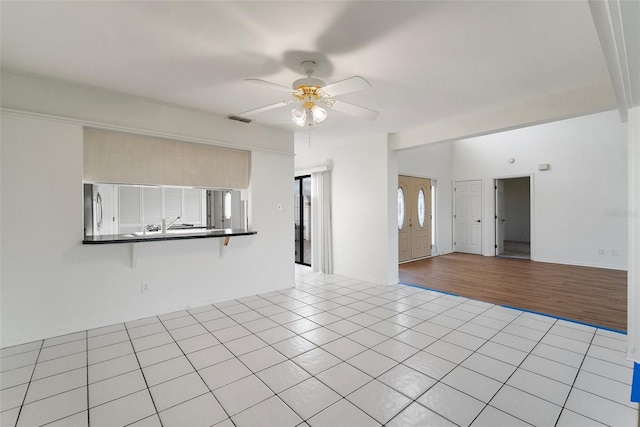 unfurnished room featuring ceiling fan and light wood-type flooring