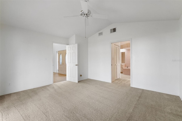 unfurnished room featuring ceiling fan, light colored carpet, and lofted ceiling