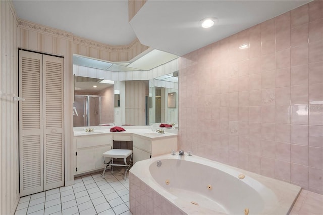 bathroom with tile patterned floors, vanity, plus walk in shower, and tile walls