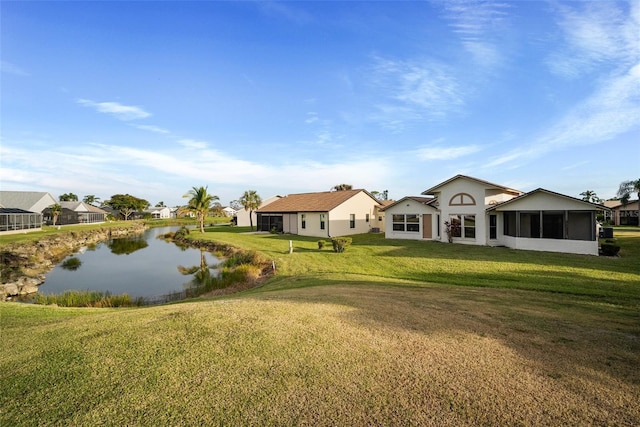 exterior space with a water view and a lawn