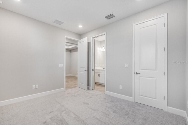 unfurnished bedroom featuring light carpet, baseboards, and visible vents