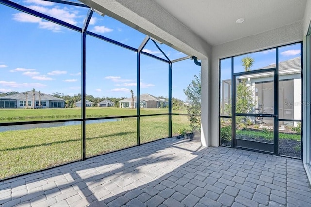 unfurnished sunroom with a water view