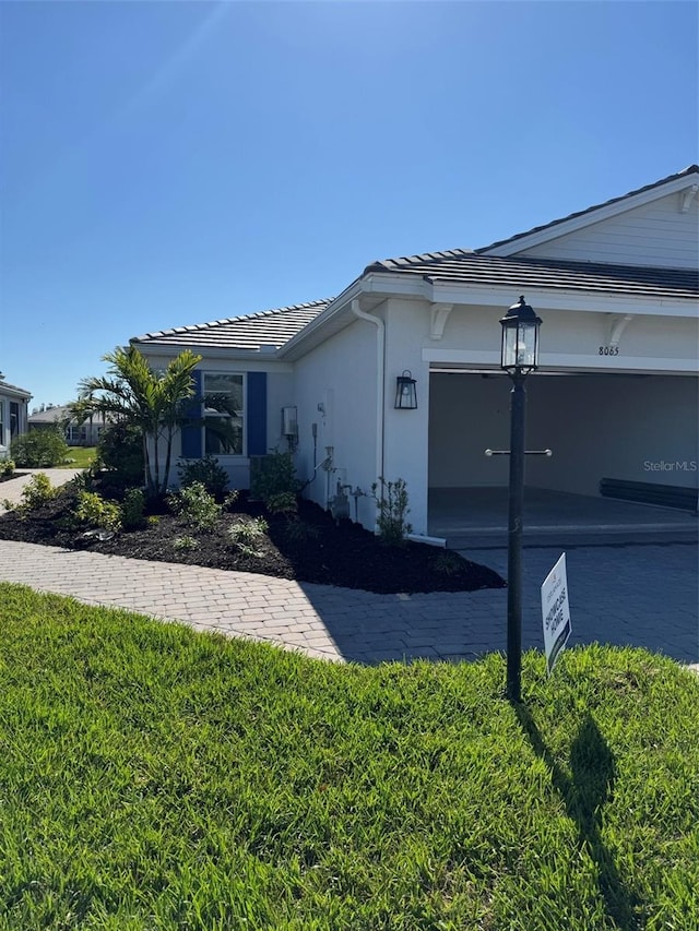 view of property exterior featuring a yard and a garage