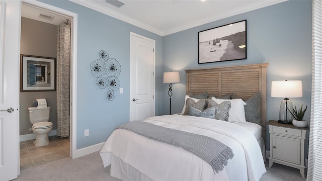 bedroom with light carpet, crown molding, and ensuite bathroom