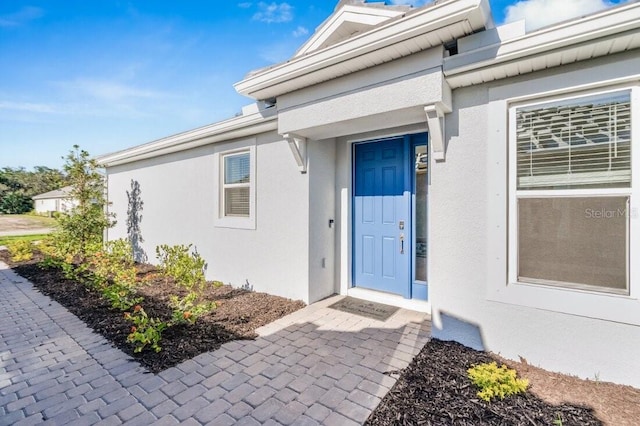 doorway to property with stucco siding