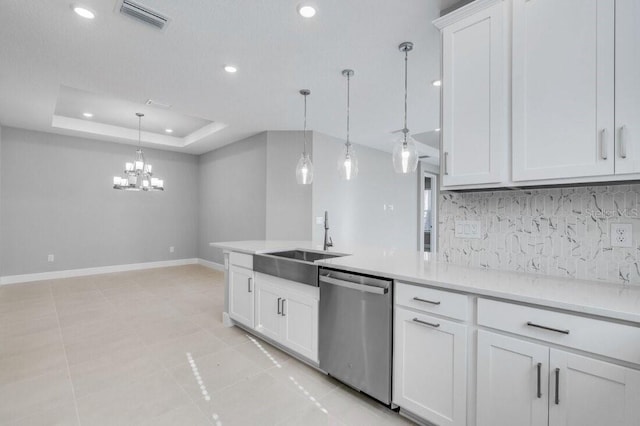 kitchen featuring visible vents, baseboards, white cabinetry, dishwasher, and a tray ceiling