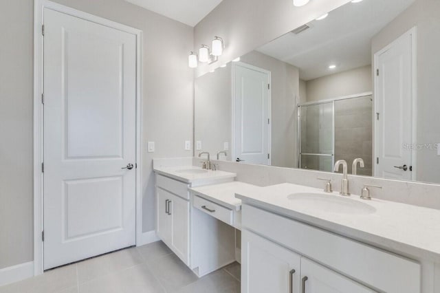 full bath with double vanity, a stall shower, a sink, and tile patterned floors