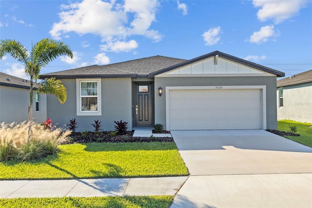 view of front of home featuring a garage and a front yard