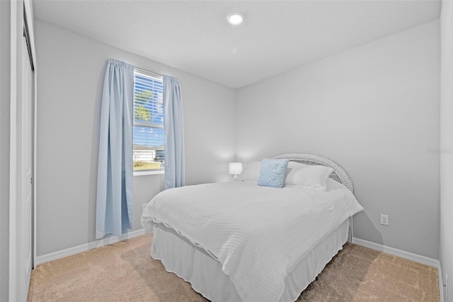 bedroom featuring light carpet