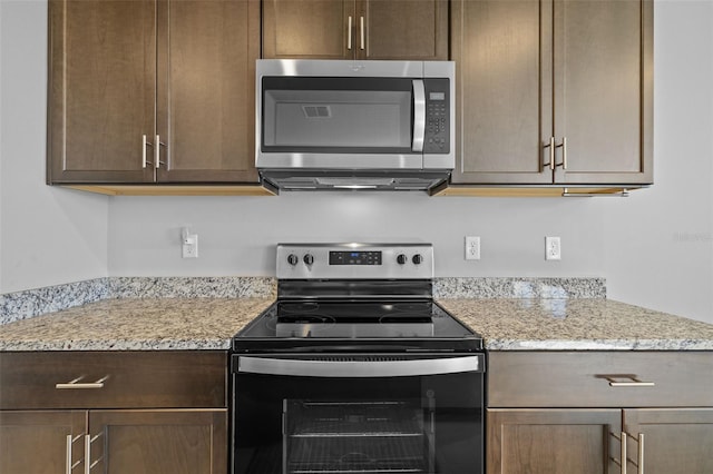 kitchen featuring light stone counters and stainless steel appliances