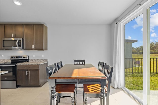 dining room featuring a wealth of natural light and light tile patterned floors