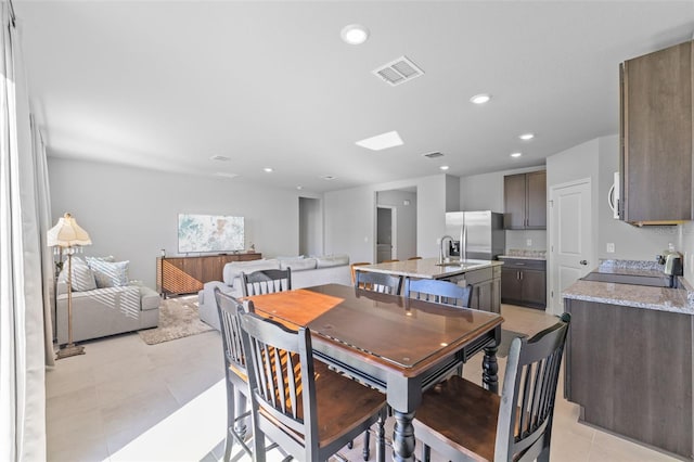 dining room with sink and light tile patterned flooring