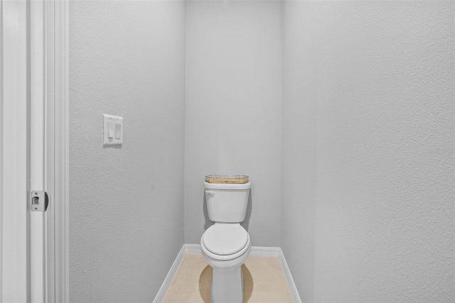 bathroom with tile patterned flooring and toilet