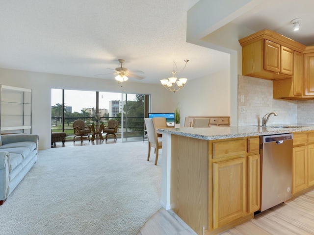 kitchen featuring dishwasher, ceiling fan with notable chandelier, decorative backsplash, a textured ceiling, and light colored carpet