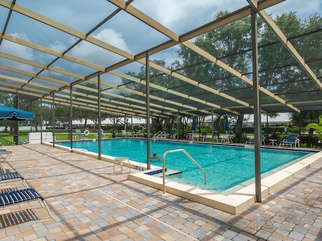 view of pool with a lanai and a patio