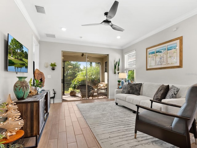 living room featuring ceiling fan, light wood-type flooring, and ornamental molding