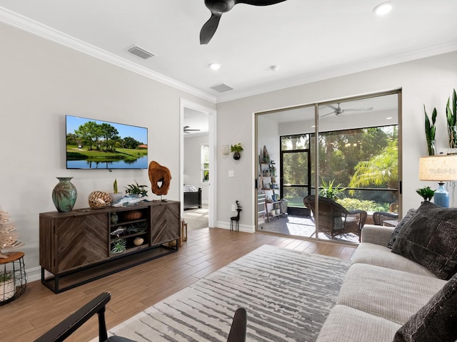 living room featuring wood-type flooring and ornamental molding