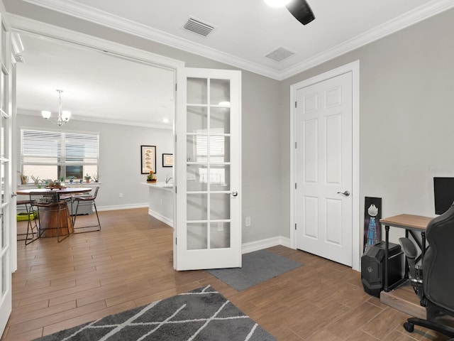 office area featuring crown molding, french doors, hardwood / wood-style floors, and an inviting chandelier