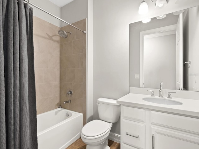 full bathroom with hardwood / wood-style floors, vanity, toilet, and shower / tub combo with curtain