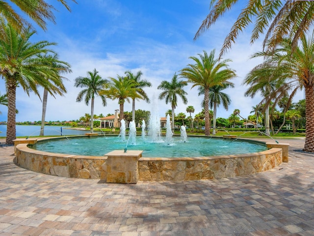 view of swimming pool with pool water feature