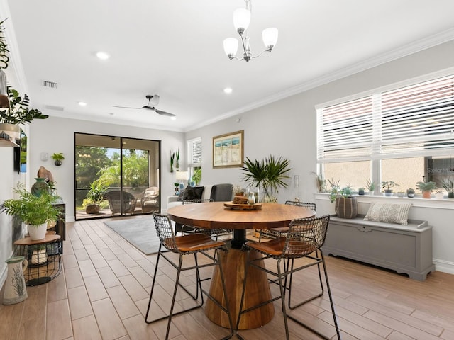 dining area featuring light hardwood / wood-style flooring, ceiling fan with notable chandelier, and ornamental molding