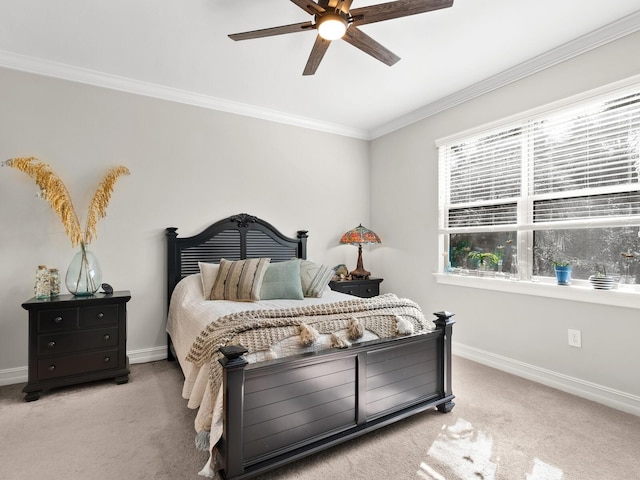 carpeted bedroom with ceiling fan and ornamental molding