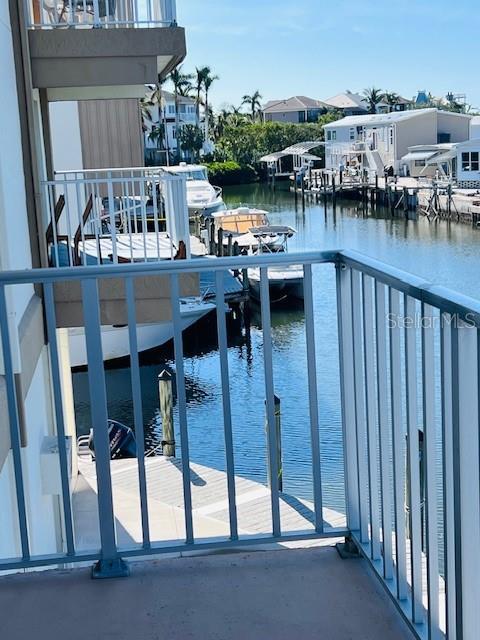 view of pool featuring a water view and a boat dock