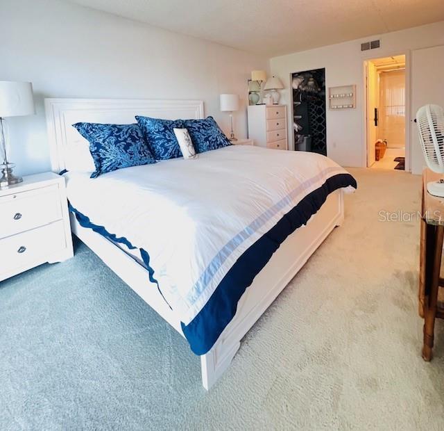 bedroom with carpet and ensuite bathroom