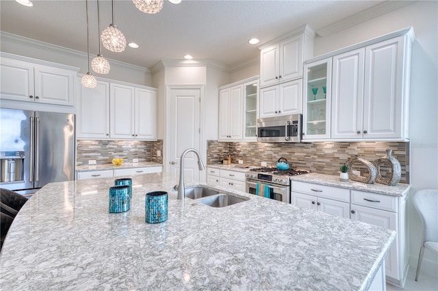 kitchen with white cabinets, decorative backsplash, high quality appliances, and sink