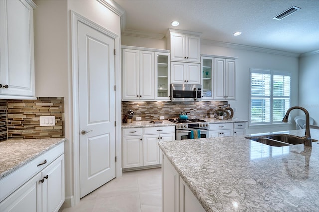 kitchen featuring white cabinets, sink, and appliances with stainless steel finishes