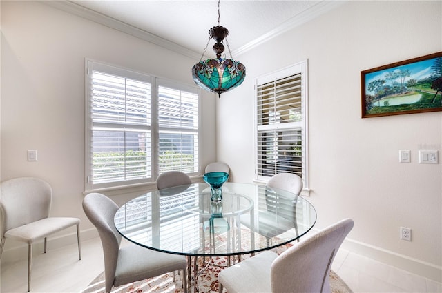 dining space featuring crown molding