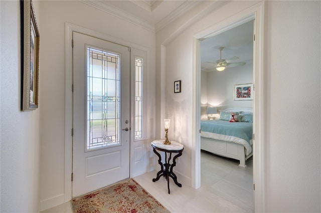 foyer featuring ceiling fan and ornamental molding