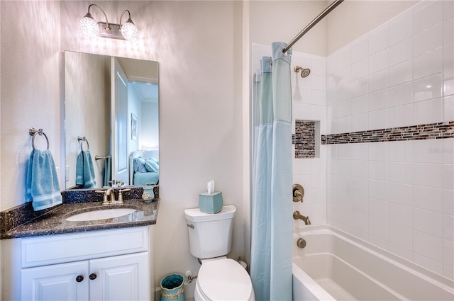 full bathroom with shower / tub combo with curtain, vanity, and toilet