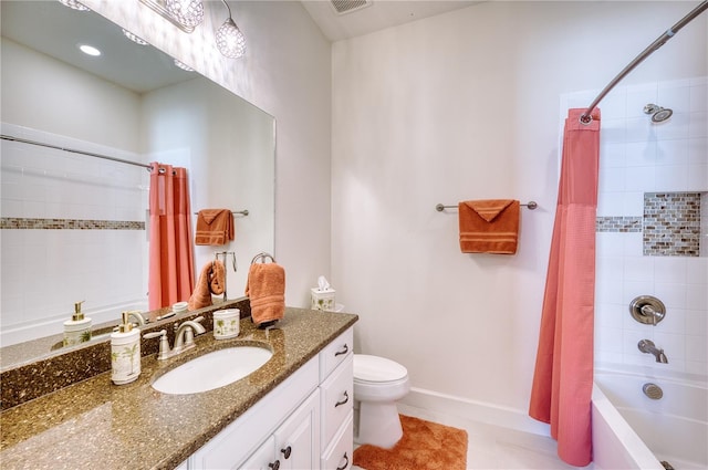 full bathroom with tile patterned floors, shower / bath combo, toilet, and vanity