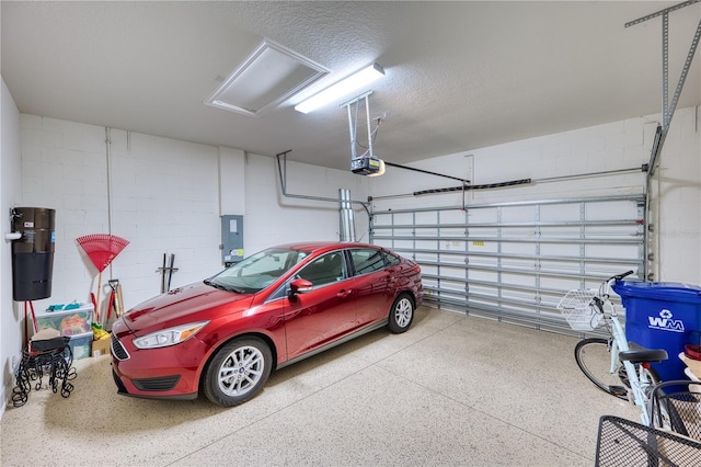 garage featuring electric panel and a garage door opener