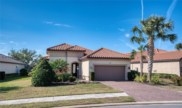 mediterranean / spanish-style house with a front lawn and a garage