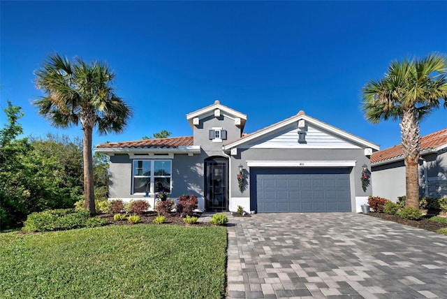 view of front of house featuring a garage and a front lawn