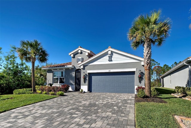 view of front of house with a front yard and a garage