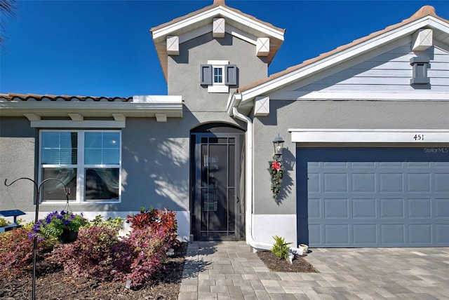 doorway to property with a garage